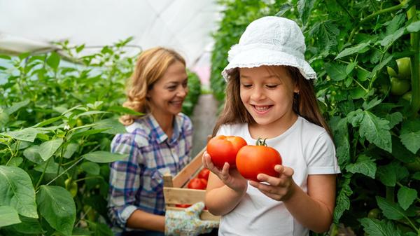 Happy mother having fun gardening with little daug