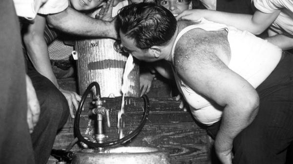 A man celebrates the end of World War II by drinki