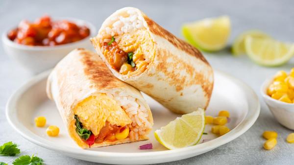 Breakfast vegetarian burrito wrap with omelette an