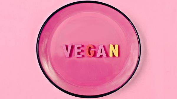Directly above shot of text " VEGAN " in plate on
