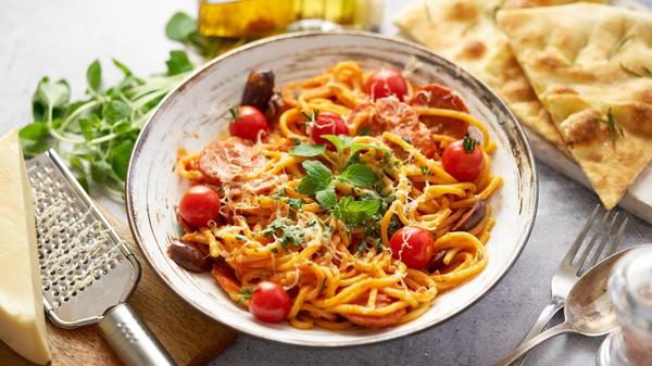 Tasty appetizing pasta served with tomato sauce Ta