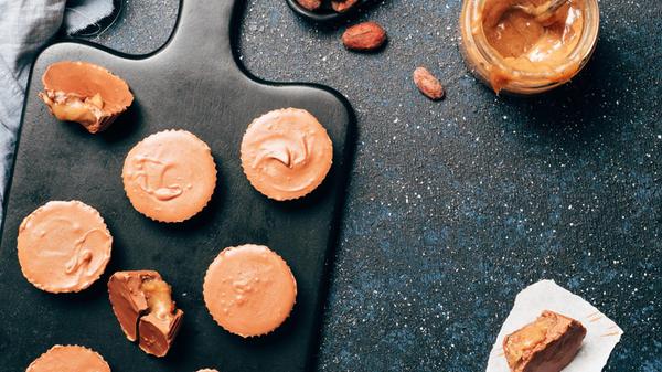 Stack of vegan chocolate cups with caramel on whit