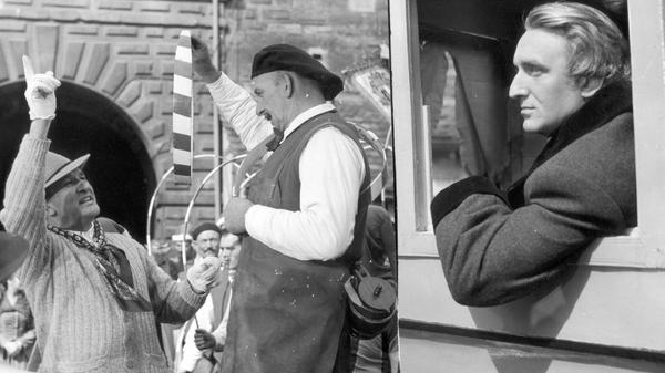 „What is happening here?“, fragt Richard Wagner aus einer Kutsche, die über den von buntem Treiben belebten Tiergärtnertorplatz fährt. Der Kutscher: „Oh, today is Häns-Sächs-Day, the most important day of Nuremberg“. „Oh yes, the shoemaker and poet!“, ruft da Wagner, und wird sogleich zu den „Meistersingern von Nürnberg“ inspiriert. Wir befinden uns im Jahr 1954 bei den Dreharbeiten für den Hollywood-Film "Frauen um Richard Wagner". Hauptdarsteller Alan Badel blickt hier ernst aus der Kutsche, während ein Herr vom "Verein Nürnberger Büttnertanz" Regisseur William Dieterle (li.) die Kunst des Reifenschwingens erklärt.