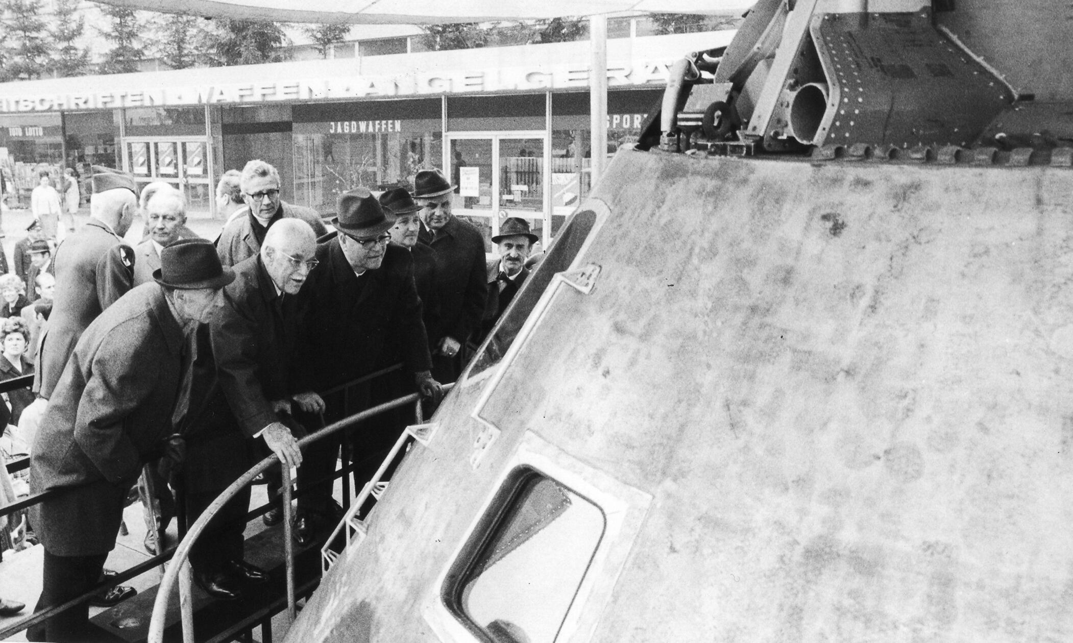„Apollo 10 im Quelle-Markt gelandet“, hieß es im November 1970 in einer Anzeige in den NN. Die Kommandokapsel des Raumschiffes, das zur Generalprobe einer Mondlandung unterwegs gewesen war, wurde für ein paar Tage auf dem Quelle-Parkplatz in Nürnberg ausgestellt. Viele kamen, um das Gefährt zu sehen, mit dem drei Astronauten im Mai 1969 den Mond 31 mal umkreist und das Gebiet inspiziert hatten, in dem zwei Monate später Apollo 11 landen sollte. Auch Gustav Schickedanz (2. von li.) und Oberstaatsanwalt Hans Sachs (hinten re.) bestaunten die Kapsel, an der Beulen und verkohlte Stellen von der gefahrvollen Reise zeugten.