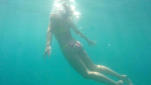 Young woman rises from the sea underwater model re
