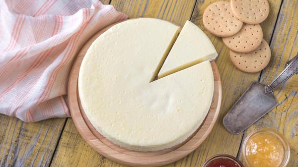 Traditional cheesecake on the wooden table PUBLICA