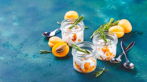 Natural yogurt with pieces of apricots and rosemar