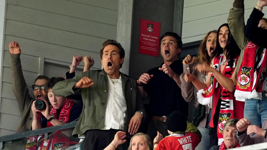 Auf der Tribüne bejubelte Miteigentümer Reynolds (Mitte l) den nächsten Aufstieg von Wrexham. Auf der Tribüne bejubelte Miteigentümer Reynolds (Mitte l) den nächsten Aufstieg von Wrexham.