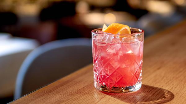 Transparent pink alcohol cocktail, vodka gin-tonic