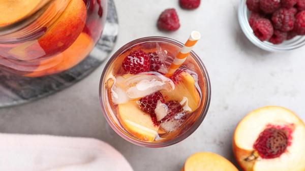 Delicious peach lemonade with soda water and raspb