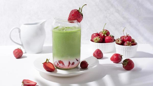 Glass with strawberry matcha latte with strawberri