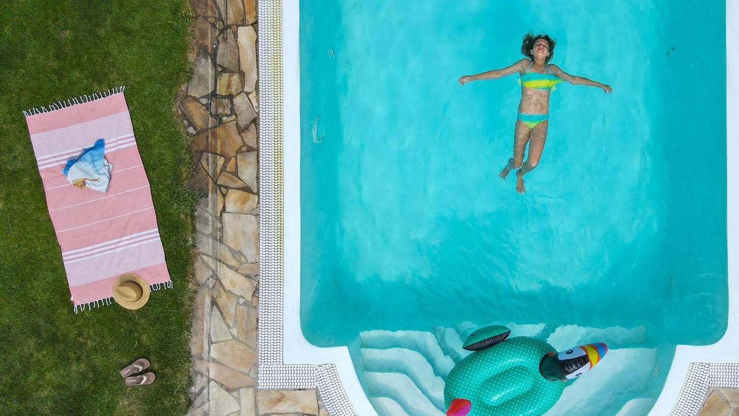 Ein Mädchen schwimmt in einem Pool in einem privaten Garten. (Symbolbild) Ein Mädchen schwimmt in einem Pool in einem privaten Garten. (Symbolbild)