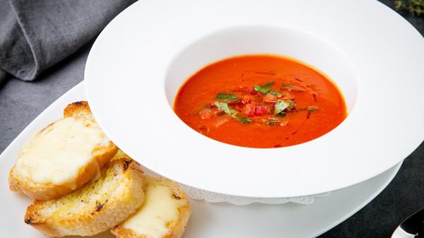 borscht with herbs in a white plate with pieces of