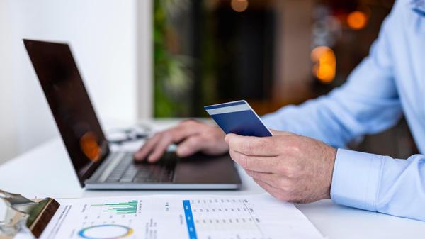 Businessman holding credit card at co working spac