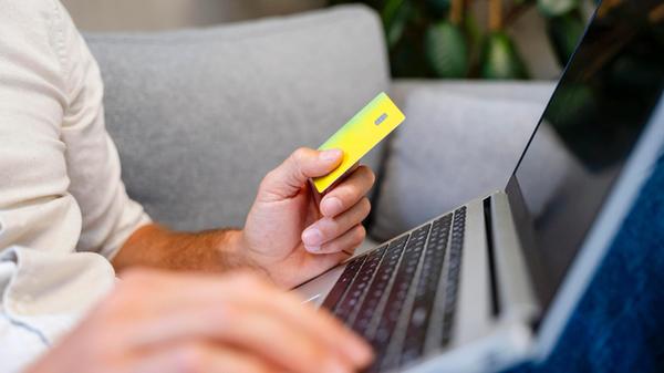 Confident person paying online at home using credi