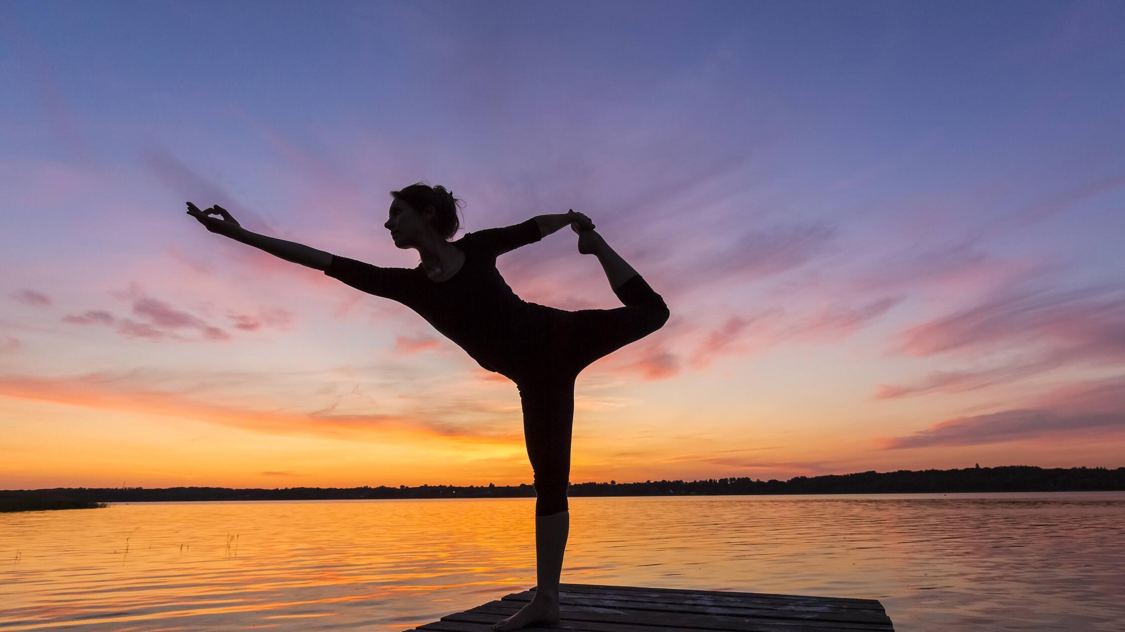 Woman practicing yoga posture Natarajasana / Lord 