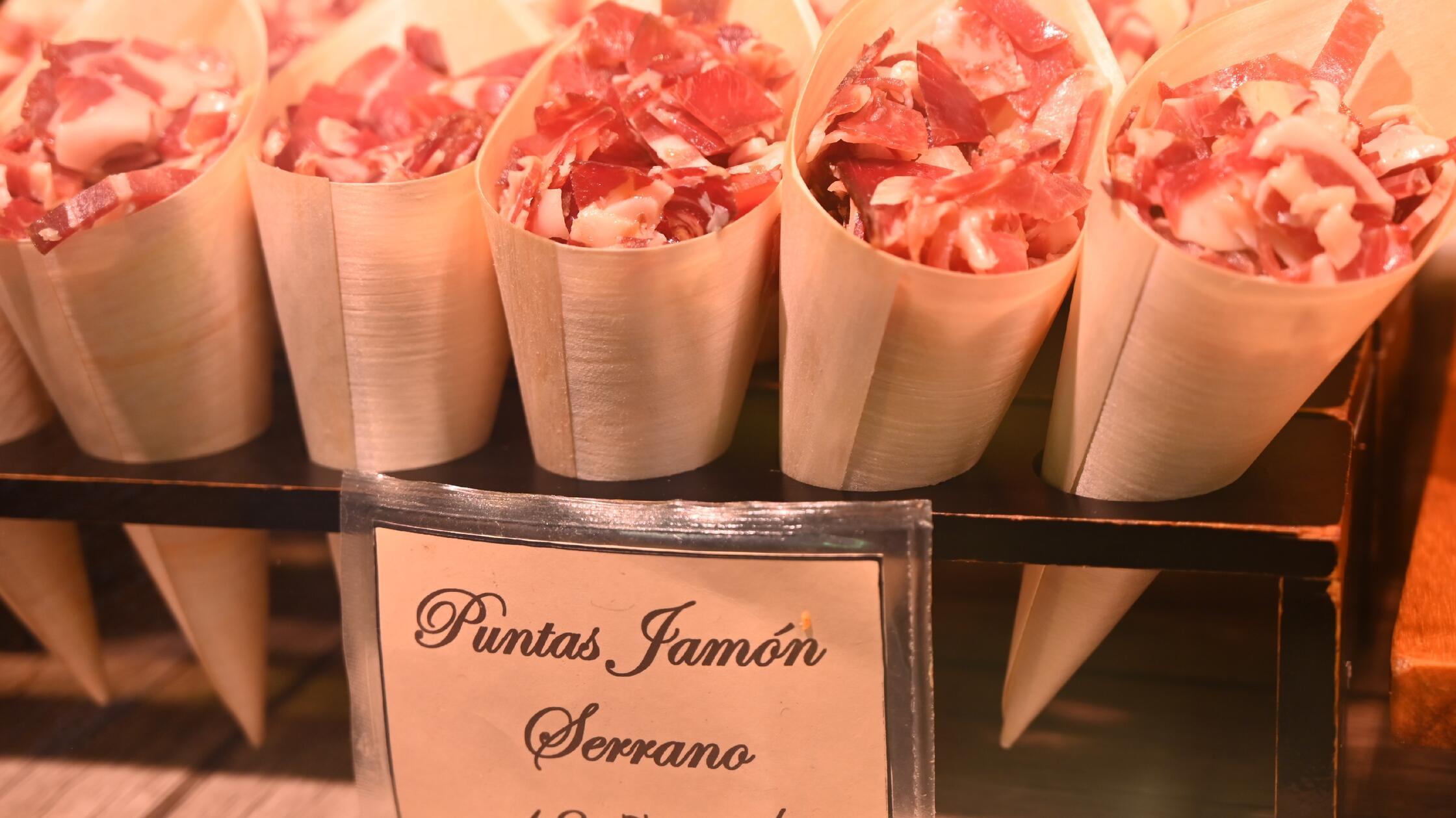 Kochkurs in Palma - kleine Schinkenstücke zum Snacken gibt es hier aus der Papiertüte.