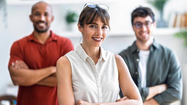 Confident team members at startup office smiling a