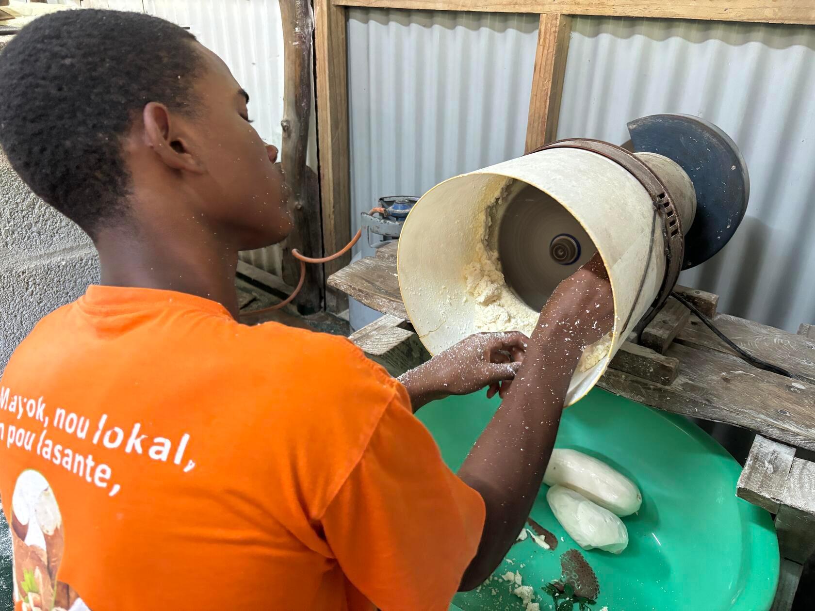 Danach werden die Knollen an einer Maschine gerieben. Vorsicht mit den Fingern ist geboten.
