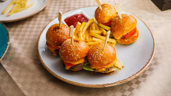 Mini burgers and fried potatoes on the plate