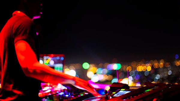 Vietnam, Ho Chi Minh City at night, DJ in the fore