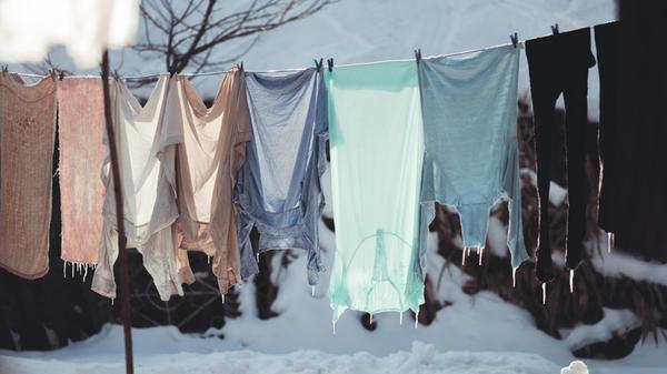 washed clothes hang on a string in the cold, harde