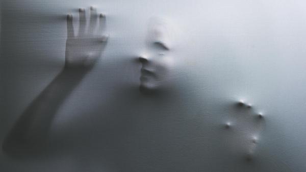 Horror, fabric and hands of a woman trapped in tex