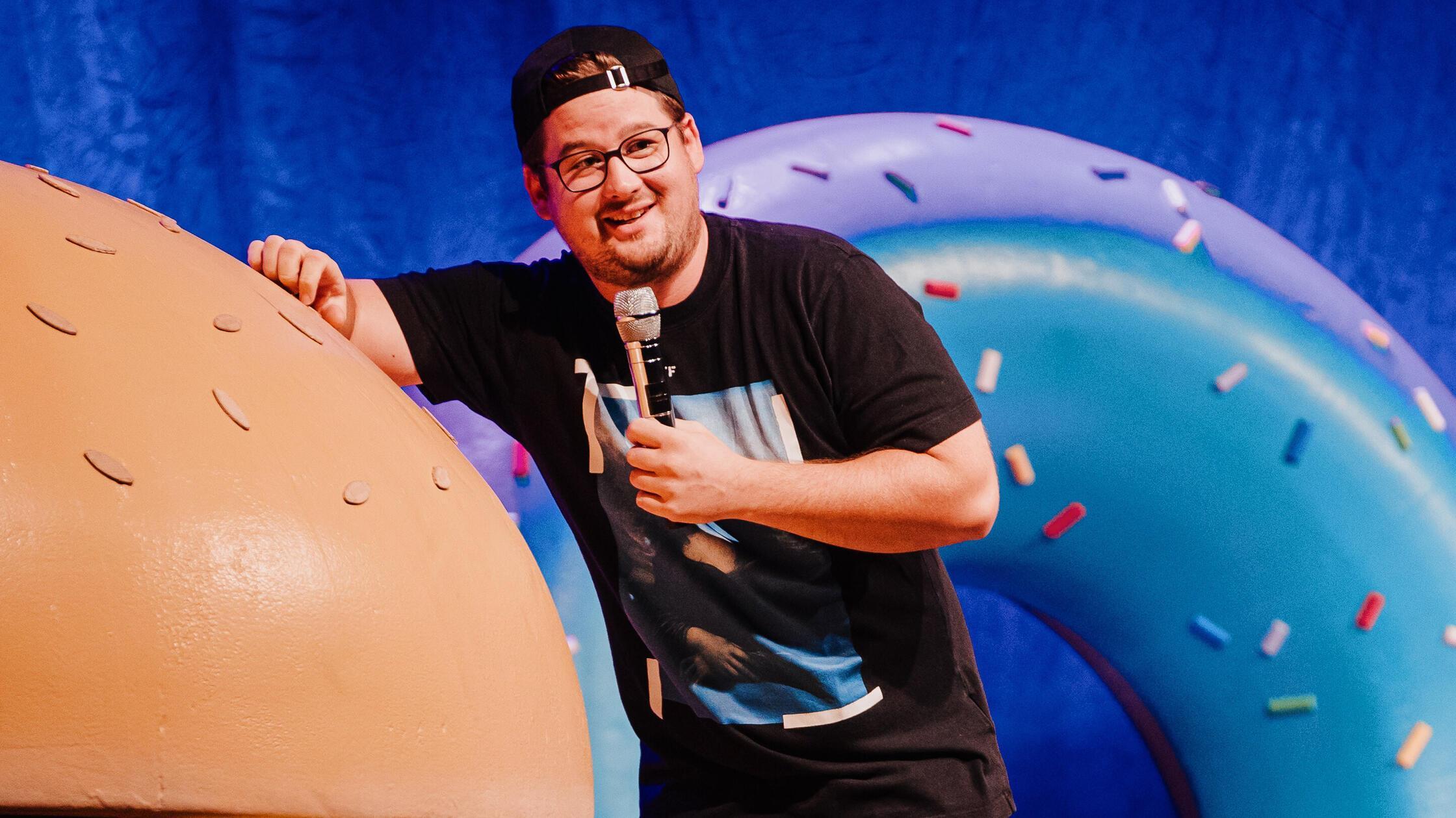 Stand-up Comedian Chris Tall With His Program SchÃ