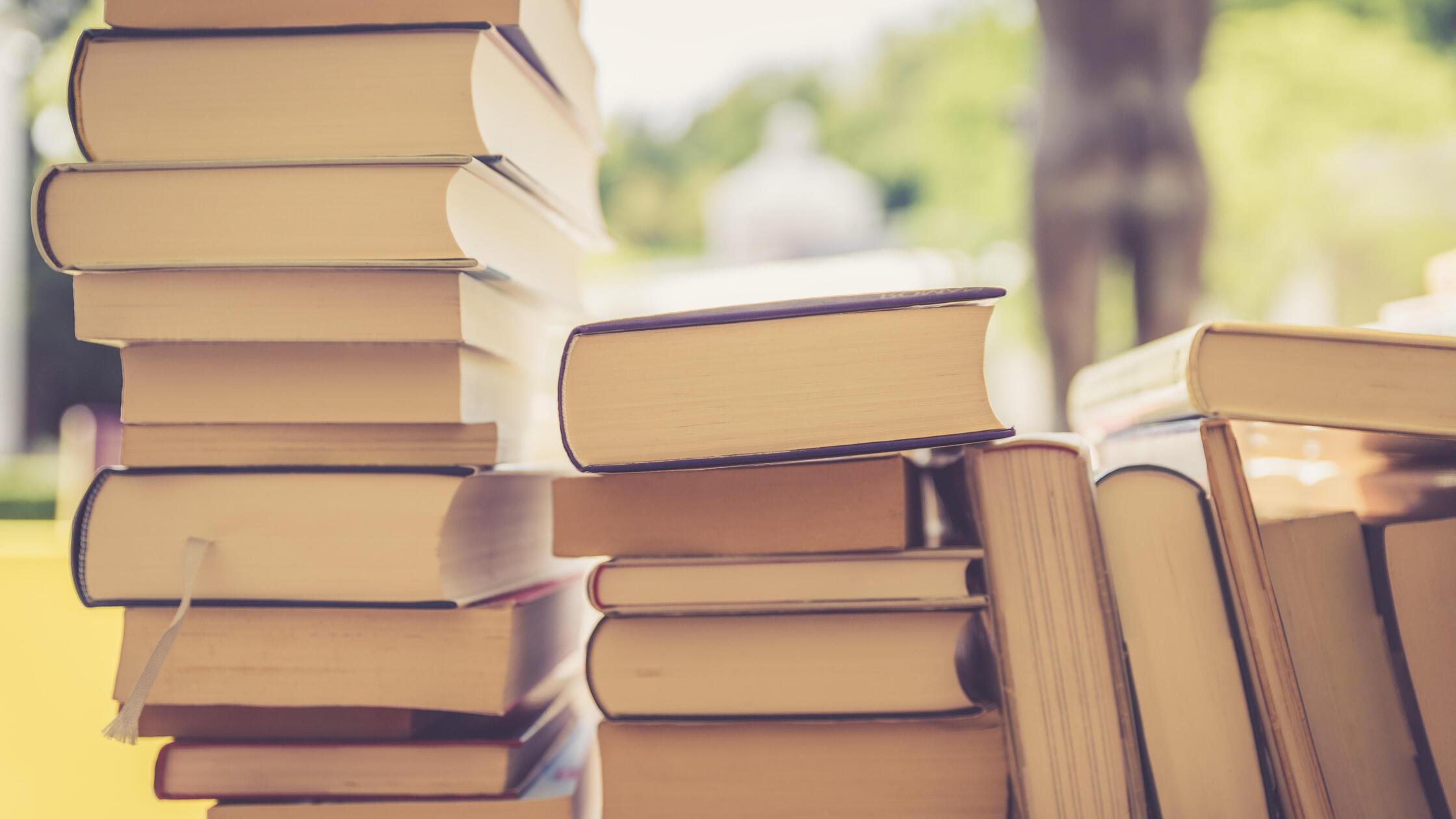 Stack of books at a charity book flea market, text