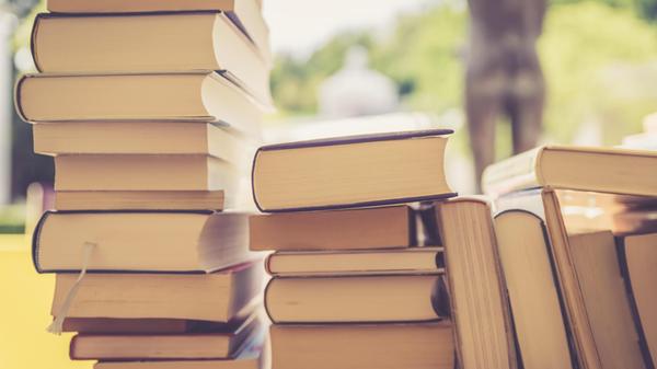 Stack of books at a charity book flea market, text