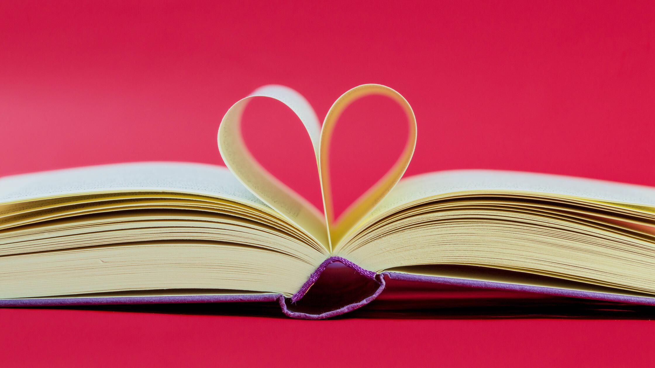 Pages of a book curved into a heart shape. Opened 