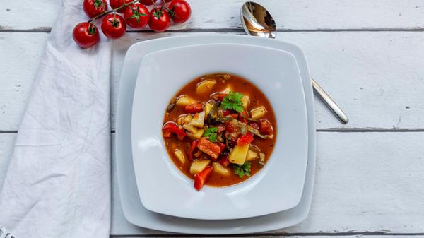 Plate of vegan goulash with potatoes, bell pepper,