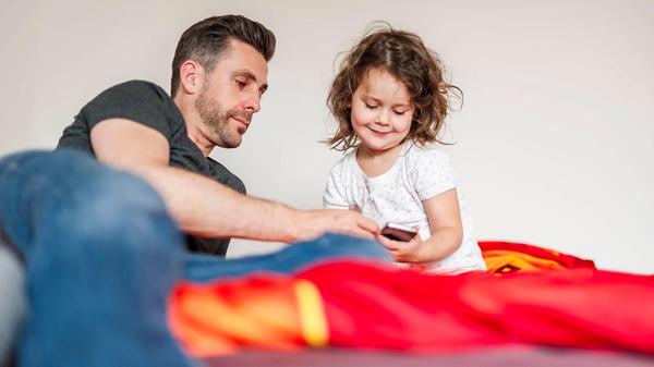 Father and daughter playing together at home in be