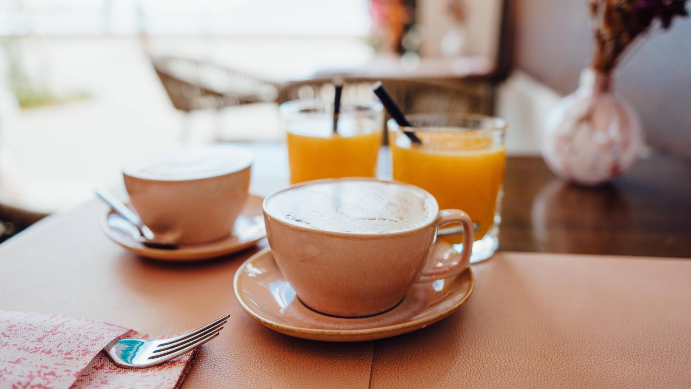 Cappuccinos and fresh orange juice at café in Port