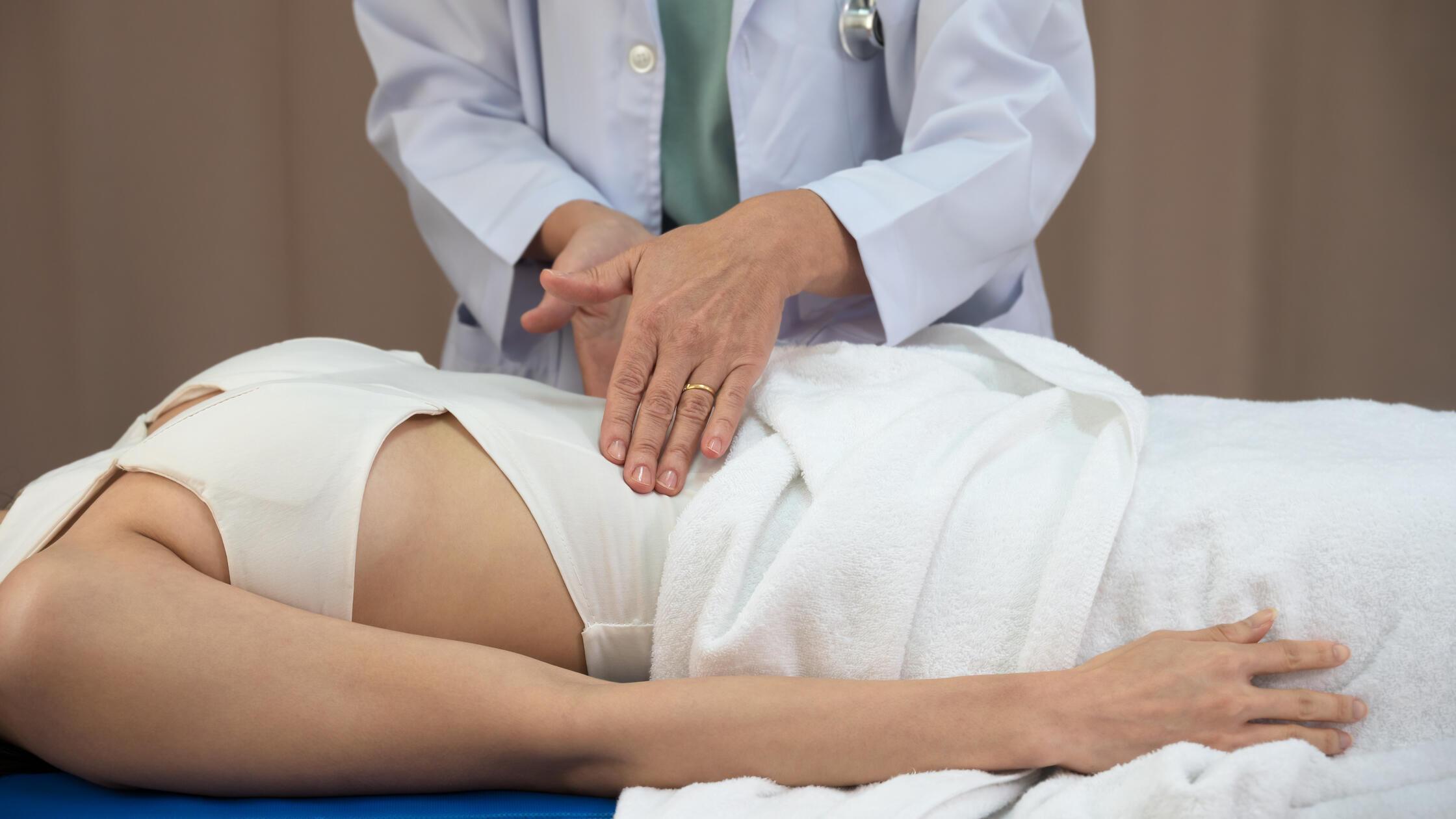Female doctor use two hands to check up of woman a