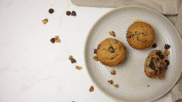 Top view of three muffins on a plate with room for