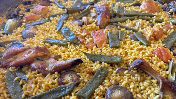 Dort gibt es auch die Paella Valenciana: unter anderem mit Kaninchen, Hühnchen, Muscheln und weißen, wie grünen Bohnen.