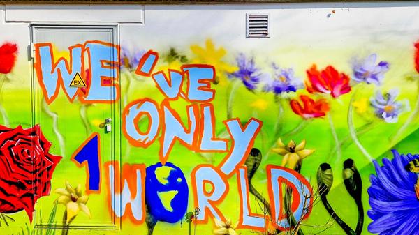 Wir haben nur die Welt - Die vielen farbigen Blumen und die Botschaft erinnern daran, dass wir nur eine Erde haben und sie schützen müssen.