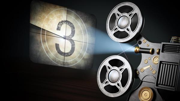 Vintage movie projector projects countdown screen.