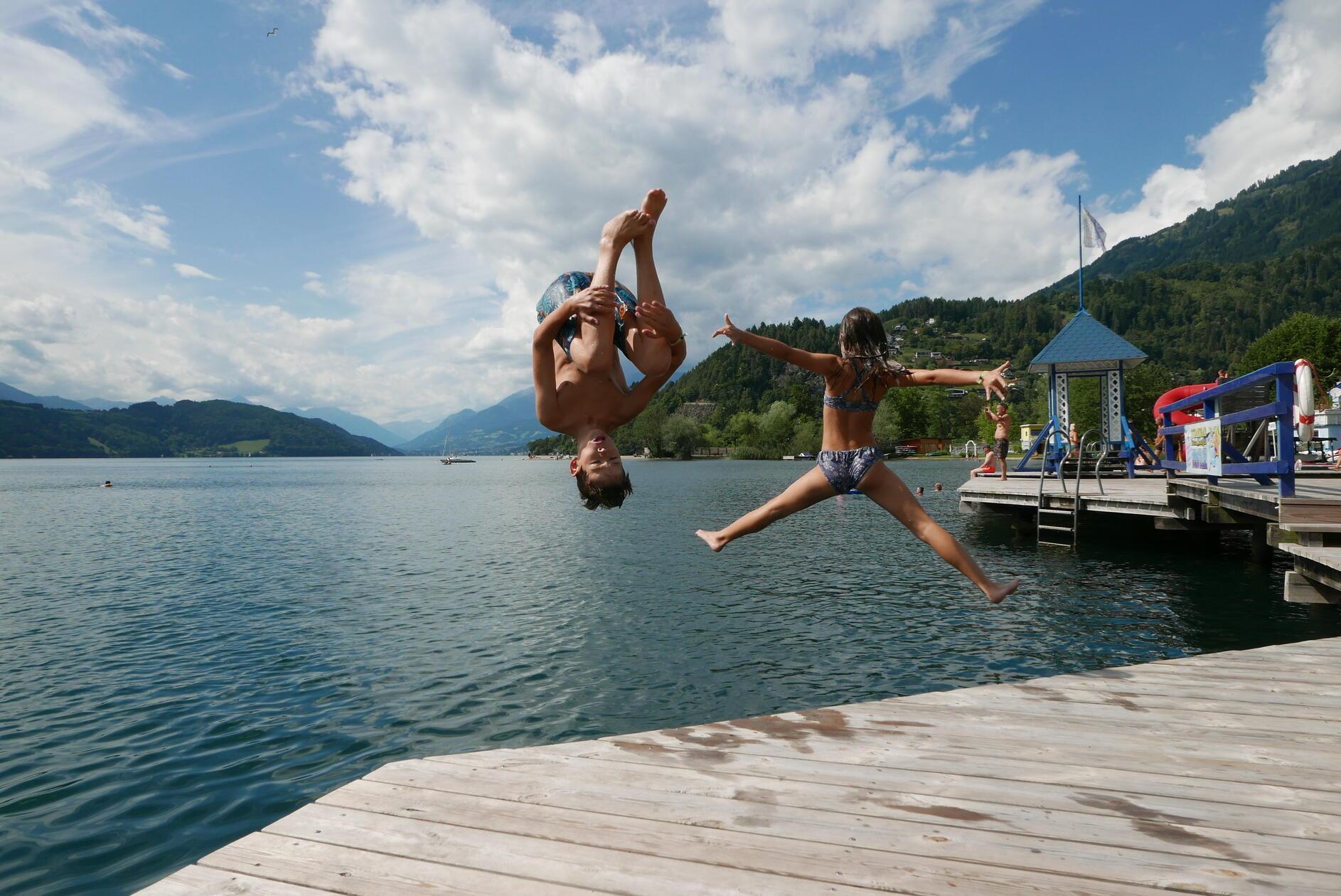 Die Kinder könnten ewig mit Anlauf vom Steg im Strandbad Burgstaller in den warmen See springen.