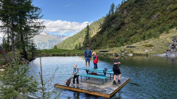 Spaß auf dem Obergailer See: Eine gemütliche Floßfahrt auf dem kleinen Gebirgssee – der perfekte Ort für eine Familienpause.
