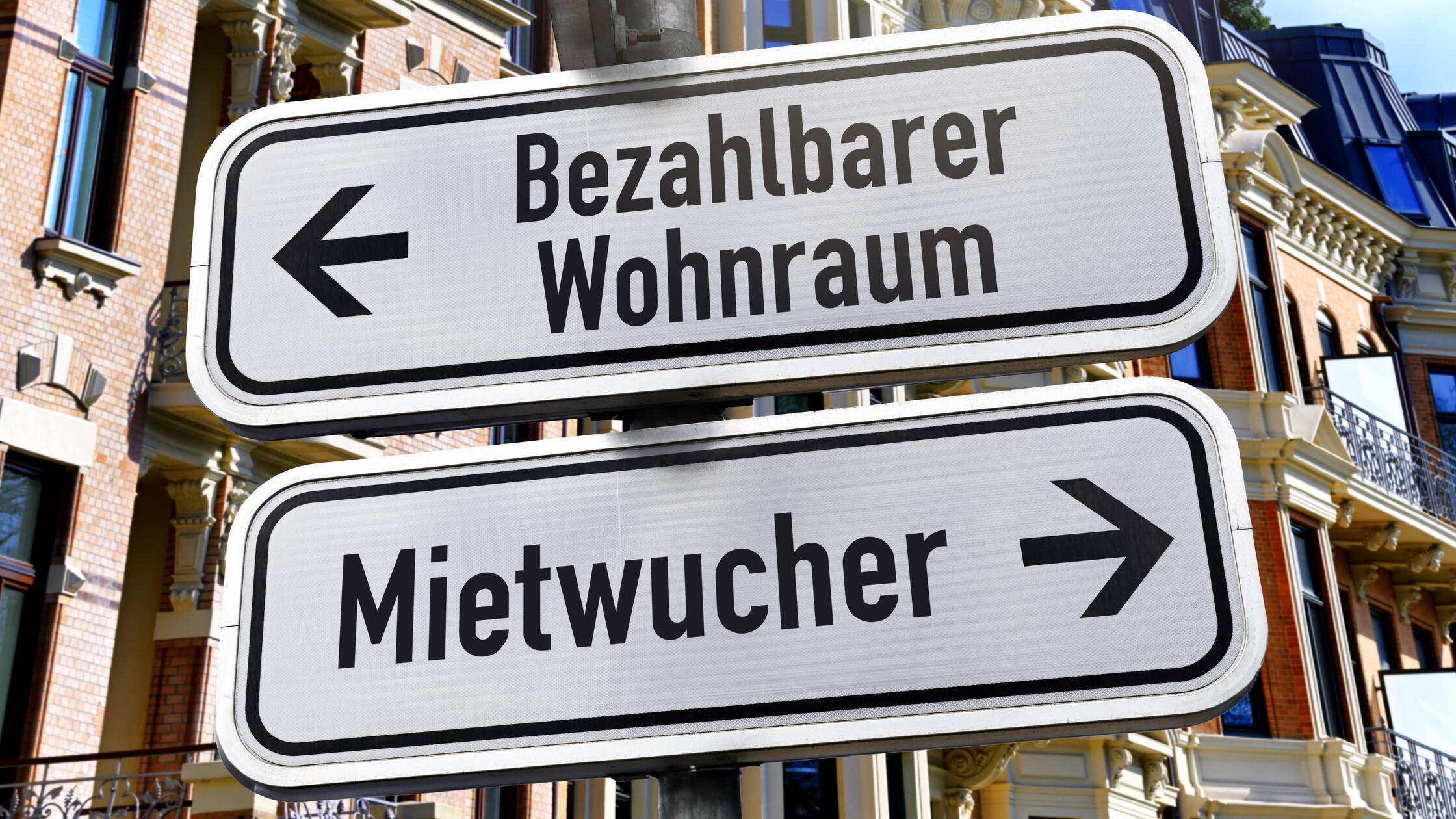 FOTOMONTAGE, Wegweiser mit Aufschrift Bezahlbarer 