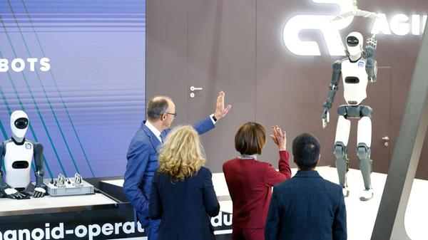 Bundeskanzler Friedrich Merz (CDU, l) steht beim E