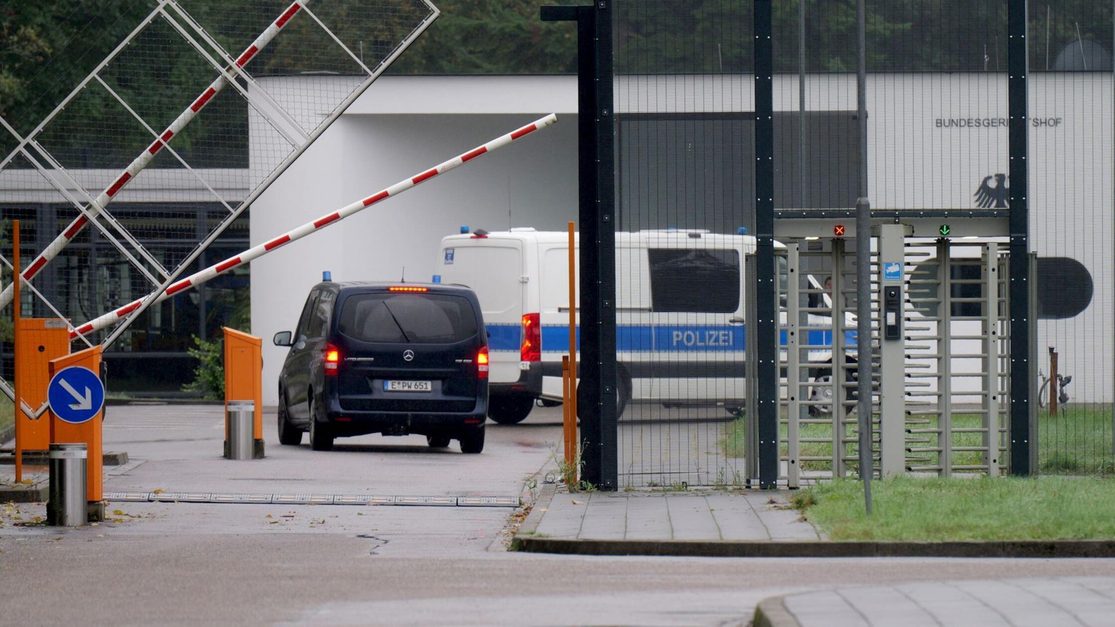 Einsatzfahrzeuge der Polizei fahren auf das Geländ