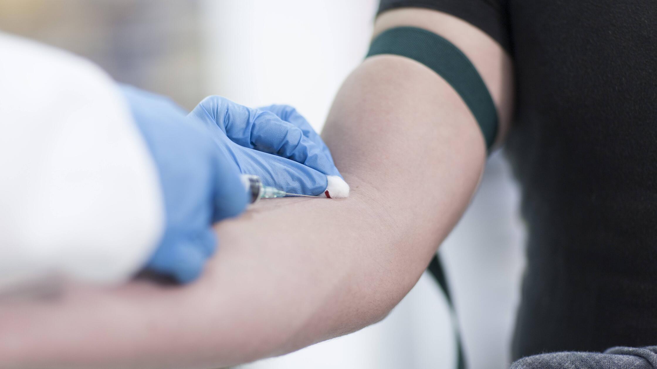 Doctor taking blood sample model released Symbolfo