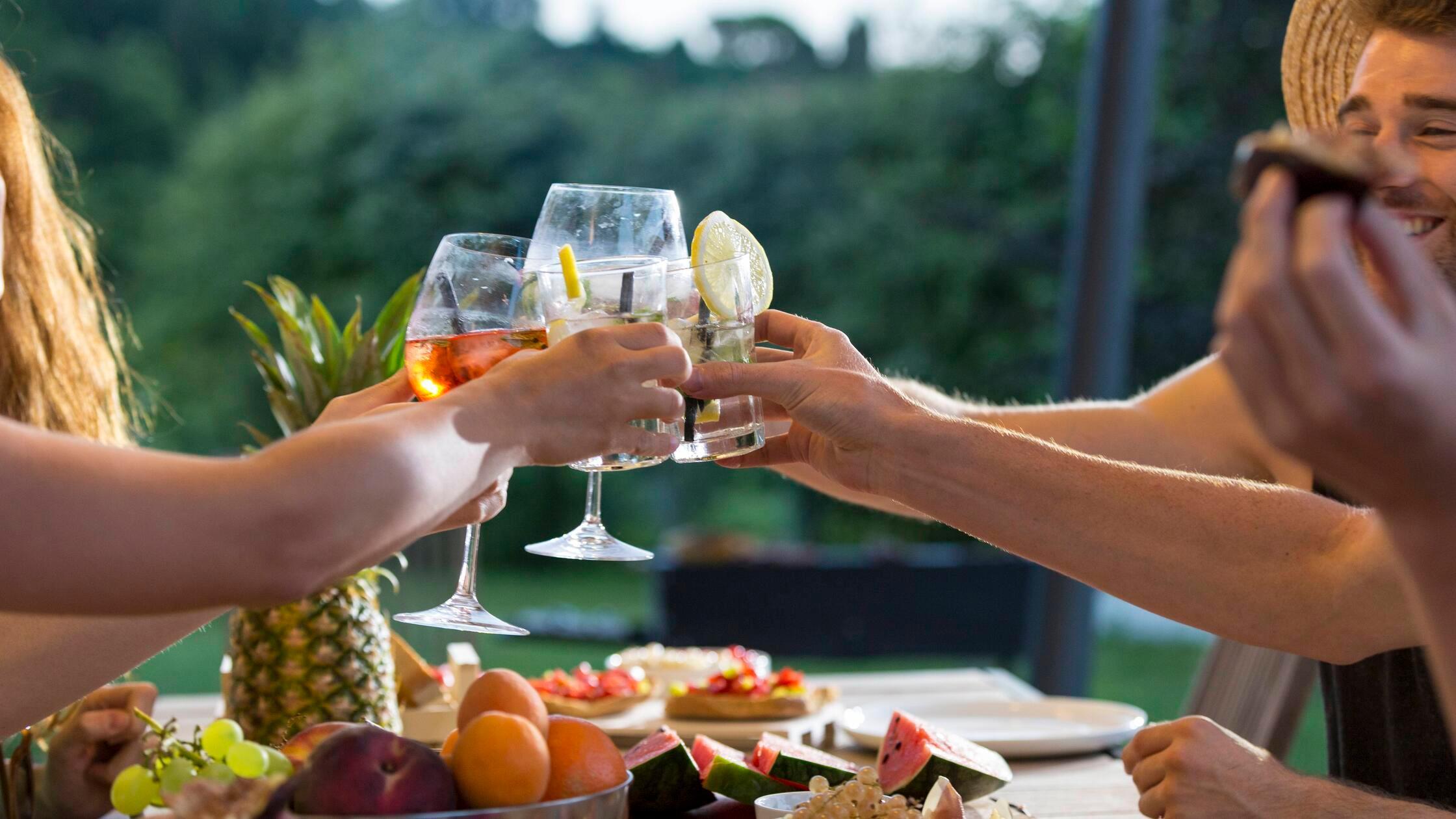 Friends clinking glasses at outdoor table