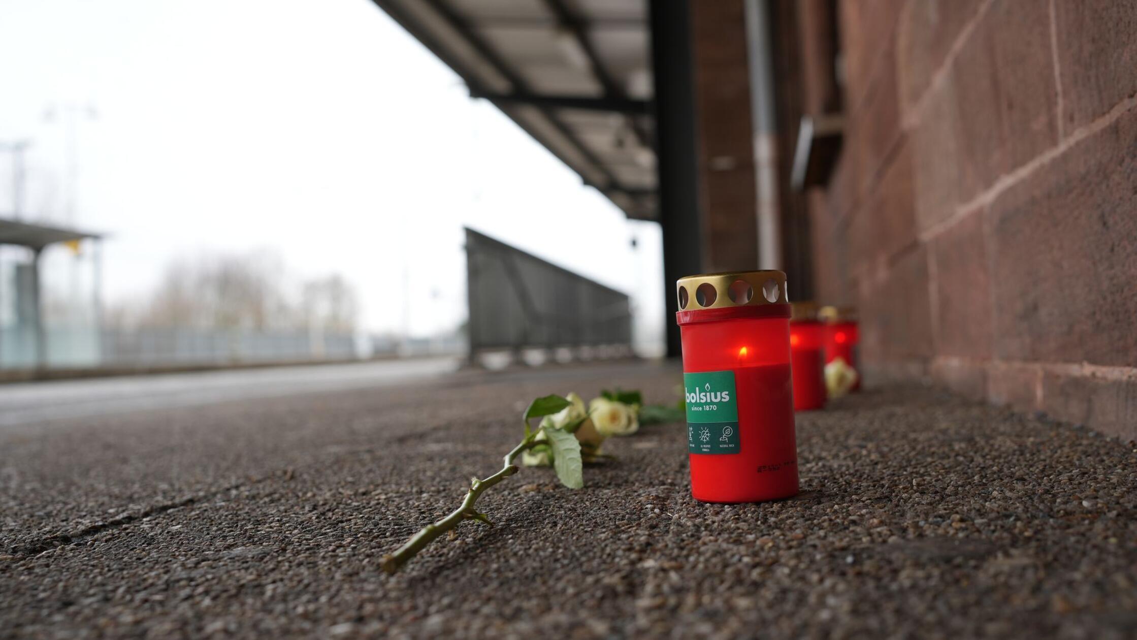 Eine Blume und Kerzen liegen am Bahnsteig nach dem