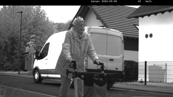 Ein Kastenwagen fährt an einer Frau mit Rollator v