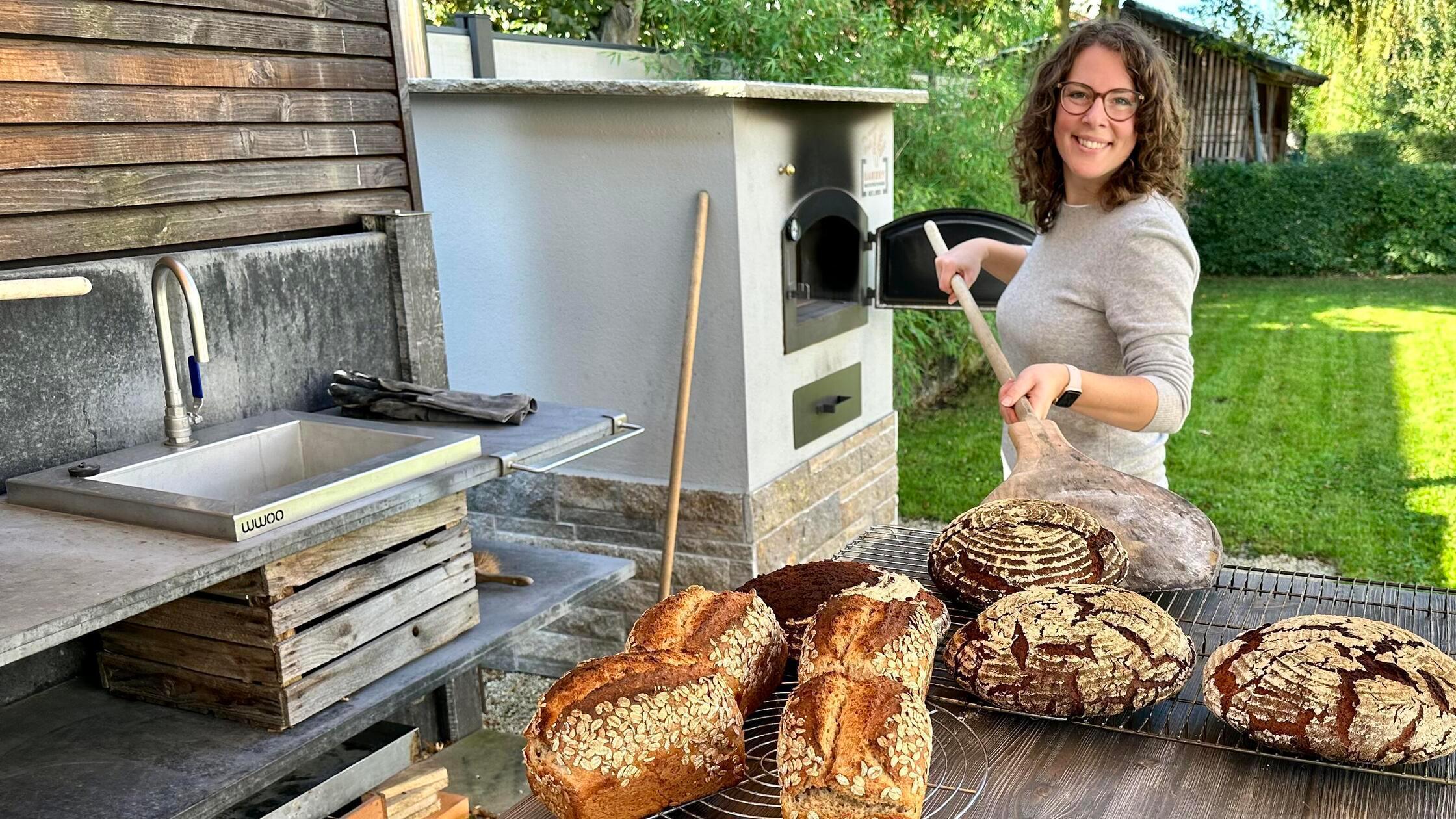 Sabine Kraus an ihrem Holzbackofen mitten im Garte