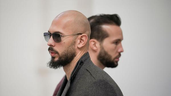 Andrew Tate (l) und sein Bruder Tristan warten im